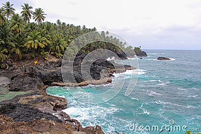 Beautiful beach with volcanic rocks and clear water in Sao Tome and Principe Island, in Africa Stock Photo