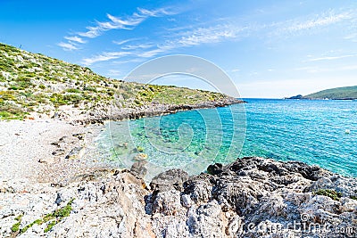 Beautiful beach and water bay in the greek spectacular coast line. Turquoise blue transparent water, unique rocky cliffs, Greece Stock Photo
