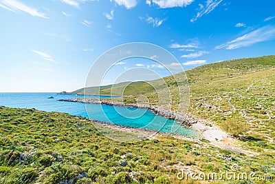 Beautiful beach and water bay in the greek spectacular coast line. Turquoise blue transparent water, unique rocky cliffs, Greece Stock Photo