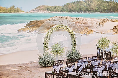 Beautiful beach wedding flower arch setting for wedding venue with panoramic ocean view Stock Photo