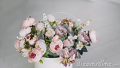 Beautiful beige purple violet pink flowers in white box Stock Photo
