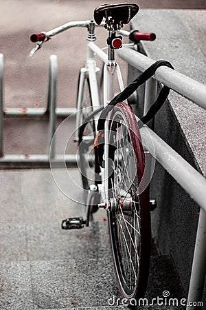 A beautiful bike stands tied in the parking lot Stock Photo