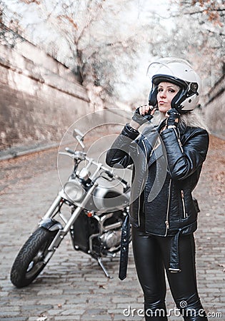 Beautiful biker woman outdoor with motorcycle. Stock Photo