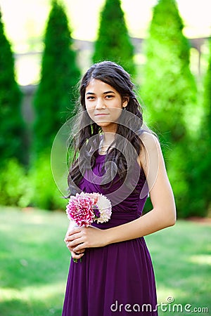 Beautiful biracial bridesmaid in purple dress, smiling Stock Photo