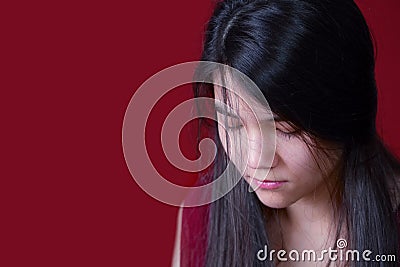 Beautiful, biracial teen girl looking down, depressed or sad, on Stock Photo