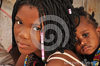 Beautiful black girl with sister on her back in Mozambique Editorial Stock Photo