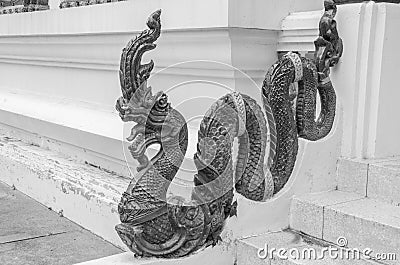 Beautiful naga sculpture beside stairs of temple Stock Photo