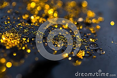 Beautiful black oil with glitter and colored bubbles in oil and watercolor. Golden sparkle particles. Macro oil ink bub Stock Photo