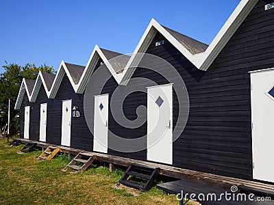 Beautiful black painted fishing huts cabins on the coast Stock Photo