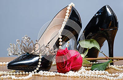 Black patent leather women`s shoes, pearls, diadem and rose Stock Photo