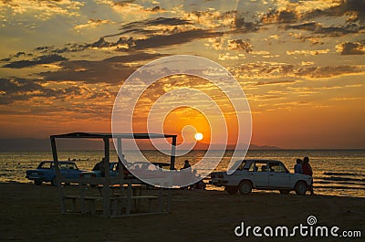 Beautiful blazing sunset landscape at Caspian sea and orange sky above it with awesome sun golden reflection on calm waves as a ba Editorial Stock Photo
