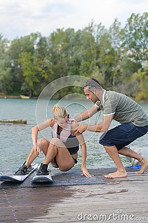 Beautiful blond active with waterskiing coach Stock Photo
