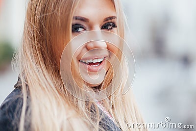 Beautiful blond face laughing outside in street Stock Photo