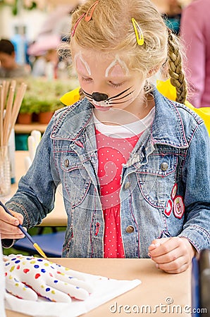 Girl with face painting in creative moment Stock Photo