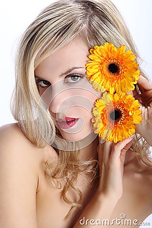 Beautiful blond girl with gerber daisy flower on a white Stock Photo