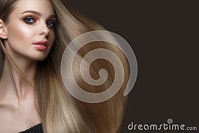 Beautiful blond girl with a perfectly smooth hair, classic make-up. Beauty face Stock Photo