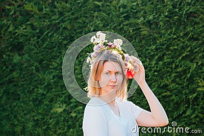 Beautiful blond woman in flower wreath. Summer solstice day. Midsummer. Stock Photo