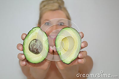 Beautiful blonde avocado woman in front of camera, close-up Stock Photo