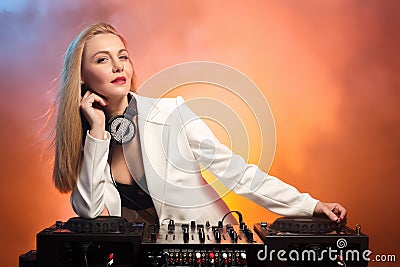 Beautiful blonde DJ girl on decks - the party Stock Photo