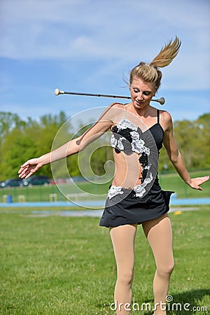 Beautiful blonde female twirler or majorette performs Stock Photo