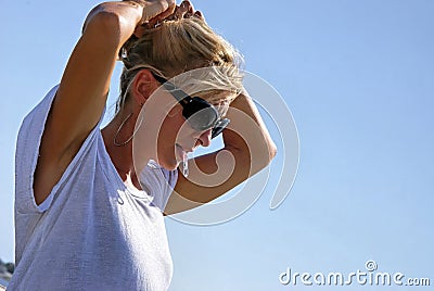 Beautiful blonde fixing hair Stock Photo