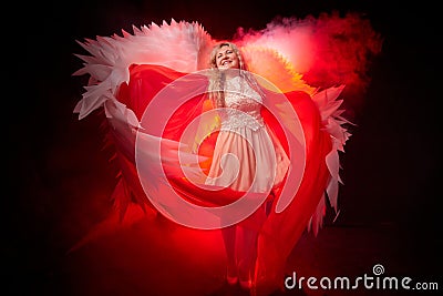 A beautiful blonde girl with curly hair and white wings looks like an nice angel Stock Photo