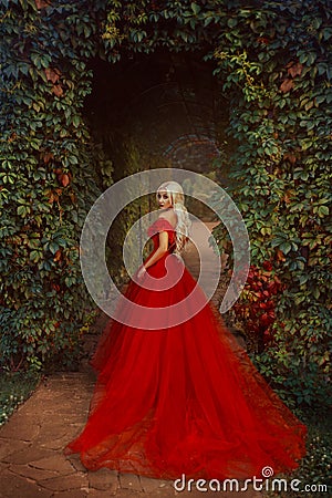 Beautiful blonde girl in a luxurious red dress Stock Photo