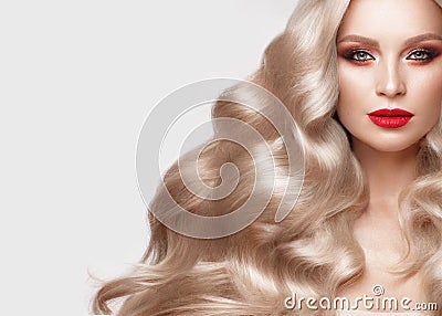 Beautiful blonde in a Hollywood manner with curls, natural makeup and red lips. Beauty face and hair. Stock Photo