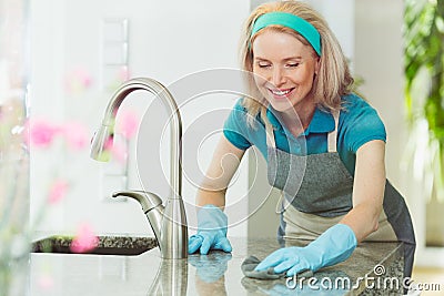 Woman cleaning kitchen work surface Stock Photo