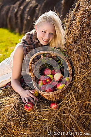 Beautiful blonde smiling woman with many apple Stock Photo