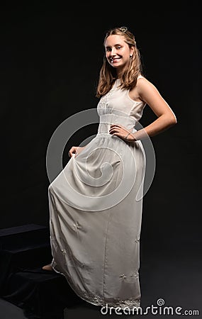 Beautiful blonde teen girl in white dress Stock Photo