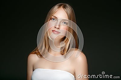 Beautiful Blonde Woman Beauty Model Girl with perfect makeup over black background. Stock Photo