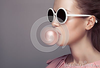 Beautiful blonde woman blowing bubble gum. Fashion portrait. Stock Photo