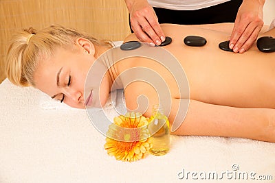 Beautiful blonde woman enyoing massage treatment in sap salon Stock Photo