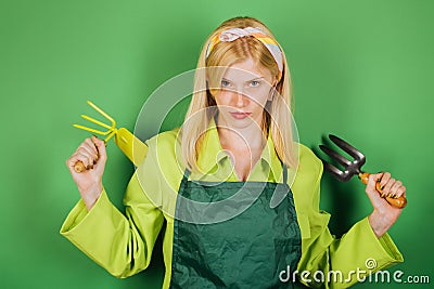 Beautiful blonde woman florist with flower. Female researcher surrounded by flowers. Woman gardener with potted plants Stock Photo