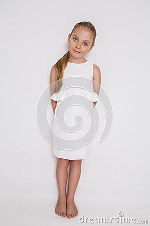 Beautiful blonde young model, cute girl, in white dress on a white background Stock Photo