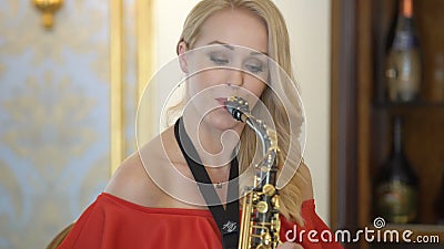 https://thumbs.dreamstime.com/x/beautiful-blonde-young-woman-playing-saxophone-sexy-girl-red-dress-plays-sax-home-party-sits-chair-practice-99157190.jpg