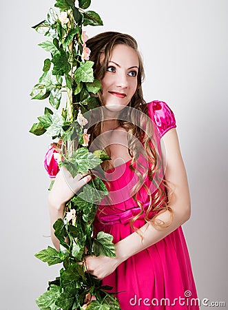 Beautiful blondy girl in red dress holding on to the green vine grapes Stock Photo