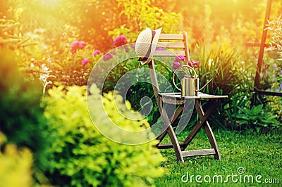 beautiful blooming summer private garden with wooden chair Stock Photo