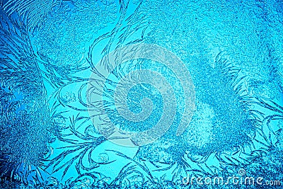 Beautiful blue frost patterns on frozen window as a symbol of Christmas wonder. Christmas or New year background Stock Photo