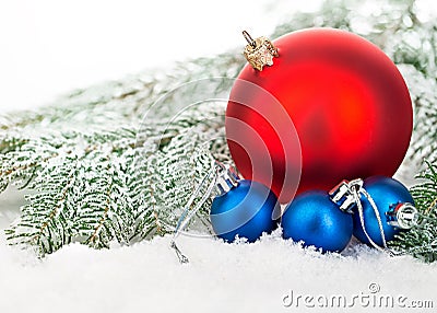 Beautiful blue and red Christmas balls on frosty fir tree. Christmas ornament. Stock Photo