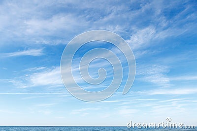 Beautiful blue sky over the sea with translucent, white, Cirrus clouds Stock Photo