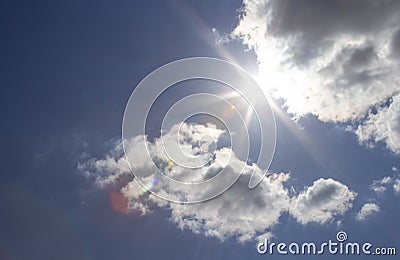 Beautiful blue sky with sunbeams and clouds. Sun rays Stock Photo