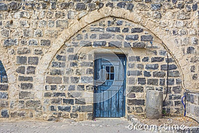 Beautiful blue traditional door in basalt wall Stock Photo