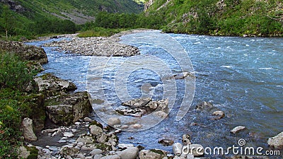 Beautiful blue water in the river in the green valle Stock Photo
