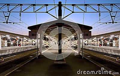 Beautiful blue hour time on a pentagon platform of local train station Stock Photo