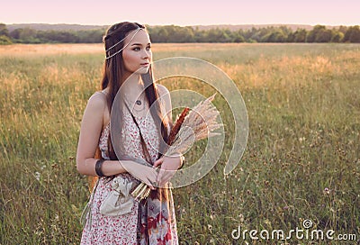 Beautiful boho girl standing in the field Stock Photo