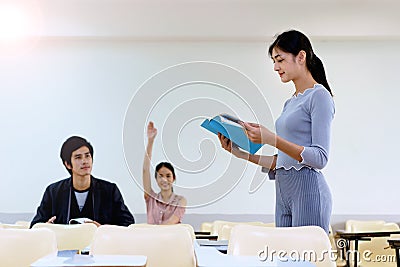 Beautiful bookworm reading in classroom. Stock Photo