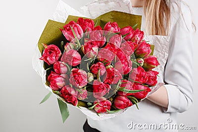 Beautiful bouquet Crimson tulip with in woman hand . colorful color mix flower Stock Photo