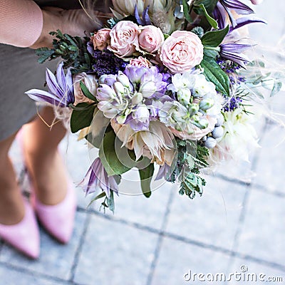 Beautiful bouquet with delicate flowers. Pink-white-purple bouquet. Bridal bouquet in female hands Stock Photo